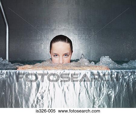 Woman immersing in jacuzzi View Large Photo Image Stock Photography - Woman immersing in jacuzzi . Fotosearch
