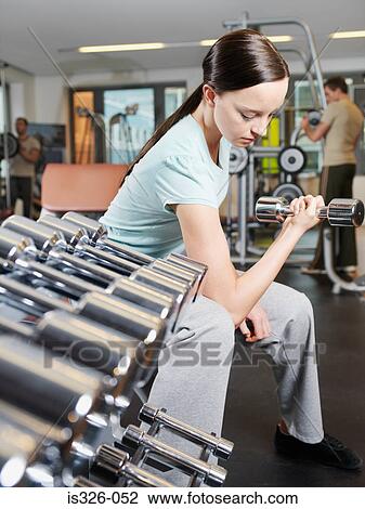 Woman weightlifting in health club View Large Photo Image Stock Image - Woman weightlifting in health club. Fotosearch