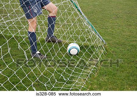 Footballer in goal with football View Large Photo Image Stock Photography - Footballer in goal with football . Fotosearch
