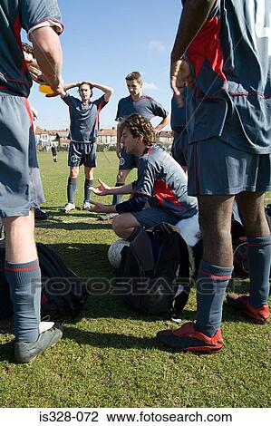 Footballers preparing for match View Large Photo Image Stock Image - Footballers preparing for match. Fotosearch