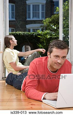 Stock Image - Gay couple at home. Fotosearch