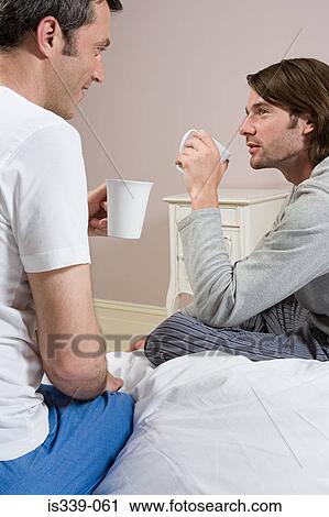 Stock Image - Gay couple drinking. Fotosearch