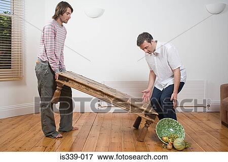 Stock Photo - Gay couple dropping table. Fotosearch