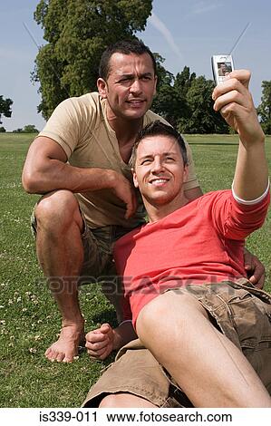 Gay couple photographing themselves View Large Photo Image Stock Image - Gay couple photographing themselves. Fotosearch