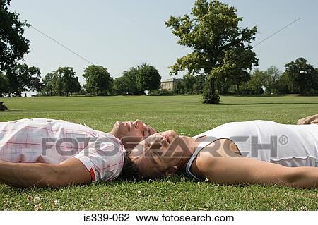 Stock Image - Gay couple sunbathing. Fotosearch