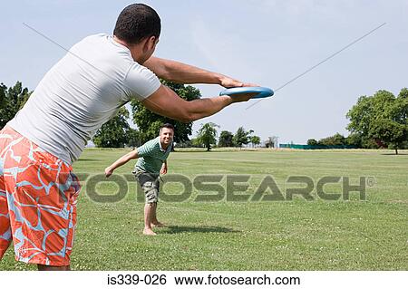 Stock Photograph - Gay couple throwing flying disc. Fotosearch