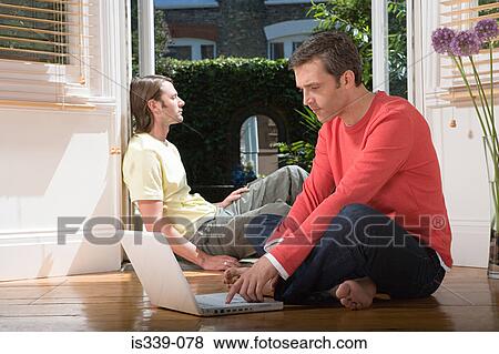 Stock Photo - Heterosexual couple at home. Fotosearch