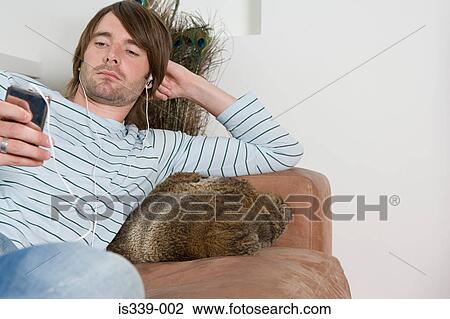 Stock Image - Man listening to music. Fotosearch