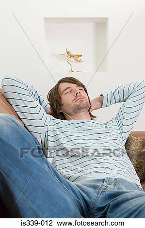 Stock Image - Man listening to music. Fotosearch