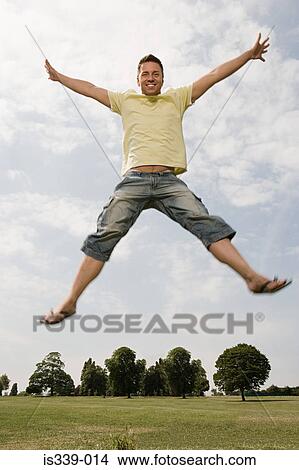 Picture - Man star jumping. Fotosearch