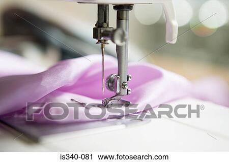 Stock Image - Fabric in a sewing machine. Fotosearch
