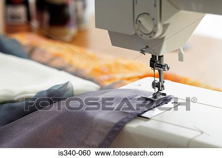 Stock Image - Fabric in sewing machine. Fotosearch