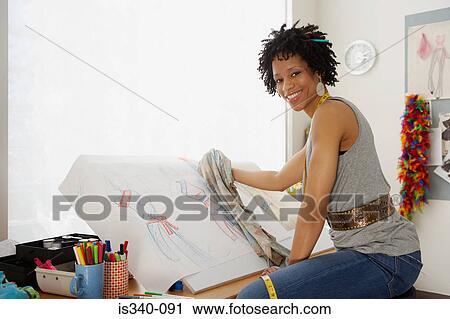 Stock Image - Fashion designer at work. Fotosearch