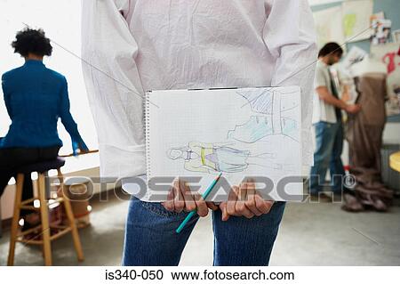 Stock Image - Fashion designer holding sketch book. Fotosearch