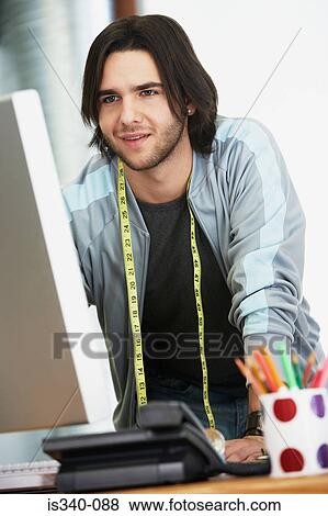 Fashion designer looking at computer View Large Photo Image Stock Photo - Fashion designer looking at computer. Fotosearch