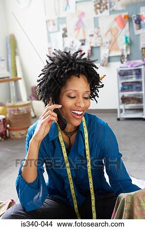 Fashion designer on cellphone View Large Photo Image Picture - Fashion designer on cellphone. Fotosearch