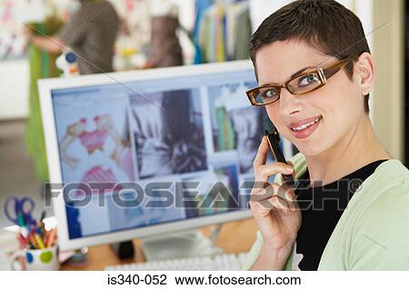Stock Image - Fashion designer on the telephone. Fotosearch
