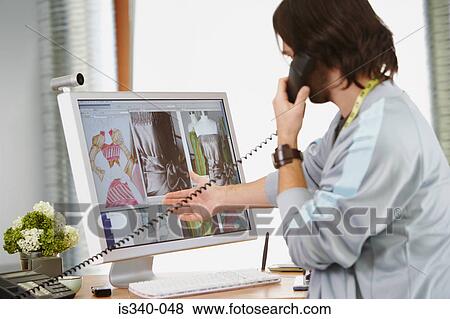 Stock Photo - Fashion designer on the telephone. Fotosearch
