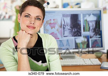 Stock Photo - Female fashion designer at her computer. Fotosearch