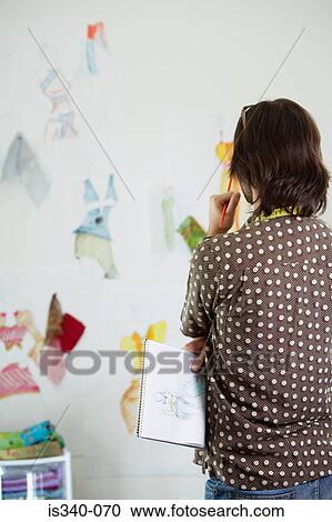 Man looking at fashion designs View Large Photo Image Stock Image - Man looking at fashion designs. Fotosearch