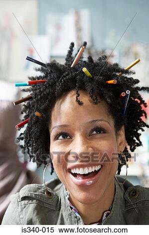 Stock Photography - Woman with pencils in her hair. Fotosearch