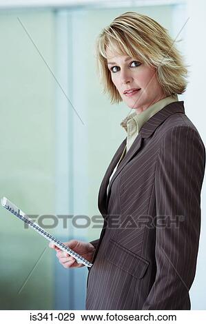 Businesswoman holding booklet View Large Photo Image Stock Photo - Businesswoman holding booklet. Fotosearch