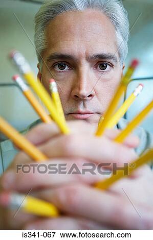 Man holding pencils View Large Photo Image Stock Photo - Man holding pencils. Fotosearch