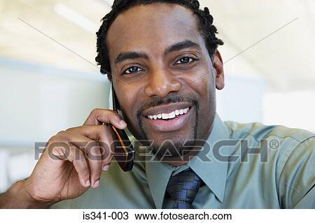 Stock Image - Man on cellphone. Fotosearch