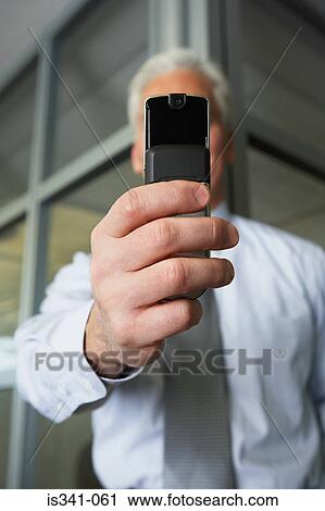 Stock Image - Man with camera phone. Fotosearch