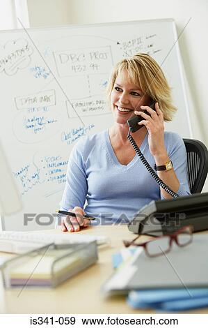 Stock Photo - Office worker using telephone. Fotosearch