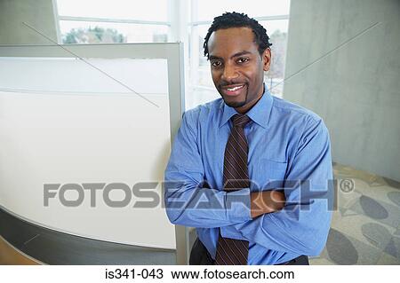 Stock Image - Office worker with arms crossed. Fotosearch