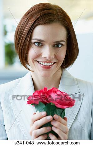 Woman holding flowers View Large Photo Image Stock Photo - Woman holding flowers. Fotosearch