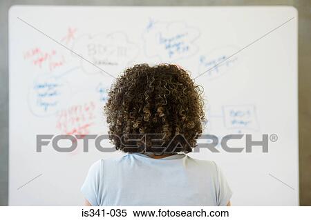Woman looking at whiteboard View Large Photo Image Stock Photography - Woman looking at whiteboard. Fotosearch