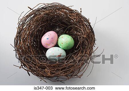 Stock Image - Colourful eggs in a nest. Fotosearch
