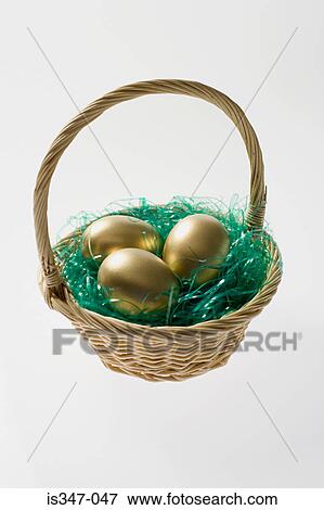 Golden eggs in a basket View Large Photo Image Stock Photo - Golden eggs in a basket. Fotosearch