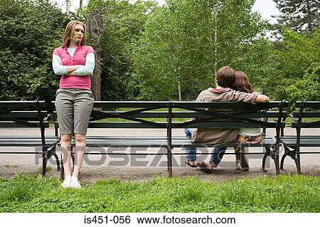 Jealous girl looking at a couple View Large Photo Image Stock Photograph - Jealous girl looking at a couple. Fotosearch