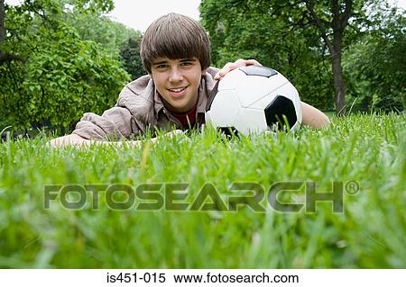 Teenage boy with a football in park View Large Photo Image Stock Photography - Teenage boy with a football in park. Fotosearch