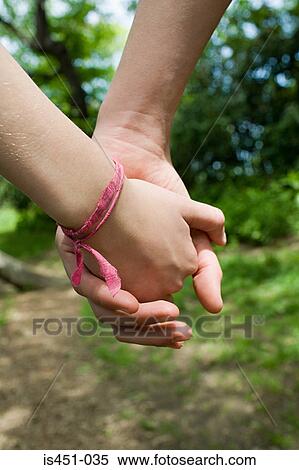 Teenage couple holding hands View Large Photo Image Stock Photography - Teenage couple holding hands. Fotosearch