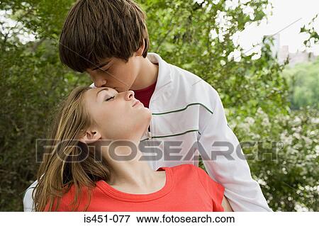 Teenage couple kissing View Large Photo Image Stock Photo - Teenage couple kissing. Fotosearch