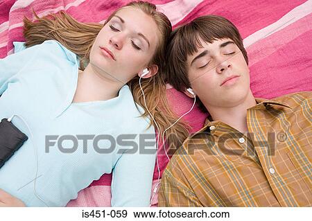 Stock Photo - Teenage couple listening to an mp3 player. Fotosearch