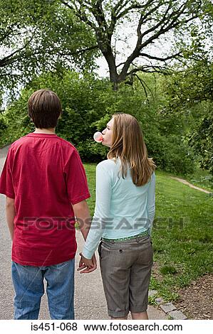 Stock Photo - Teenage girl blowing a bubble gum bubble. Fotosearch