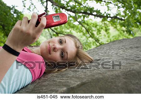 Teenage girl using a cellular telephone View Large Photo Image Stock Photography - Teenage girl using a cellular telephone. Fotosearch