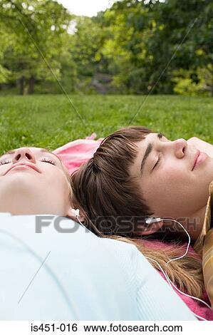 Teenagers listening to an mp3 player View Large Photo Image Stock Photograph - Teenagers listening to an mp3 player. Fotosearch