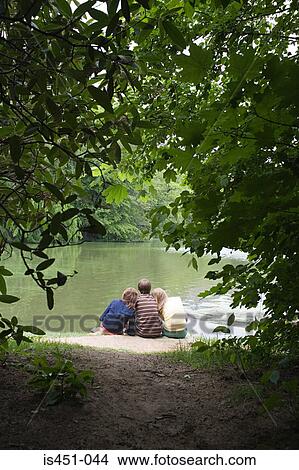 Teenagers resting near a lake View Large Photo Image Picture - Teenagers resting near a lake. Fotosearch