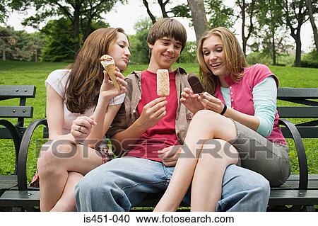 Three teenagers eating ice cream View Large Photo Image Stock Image - Three teenagers eating ice cream. Fotosearch
