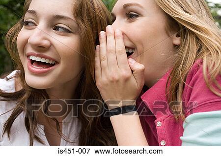 Two teenage girls gossiping View Large Photo Image Stock Photo - Two teenage girls gossiping. Fotosearch
