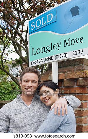 Couple by sold sign View Large Photo Image Stock Image - Couple by sold sign. Fotosearch
