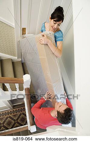 Couple carrying mattress up stairs View Large Photo Image Picture - Couple carrying mattress up stairs. Fotosearch