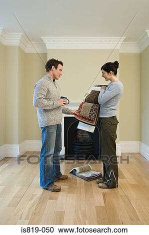 Couple choosing fabric View Large Photo Image Stock Image - Couple choosing fabric. Fotosearch