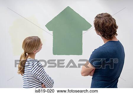 Couple looking at a painted house View Large Photo Image Stock Image - Couple looking at a painted house. Fotosearch